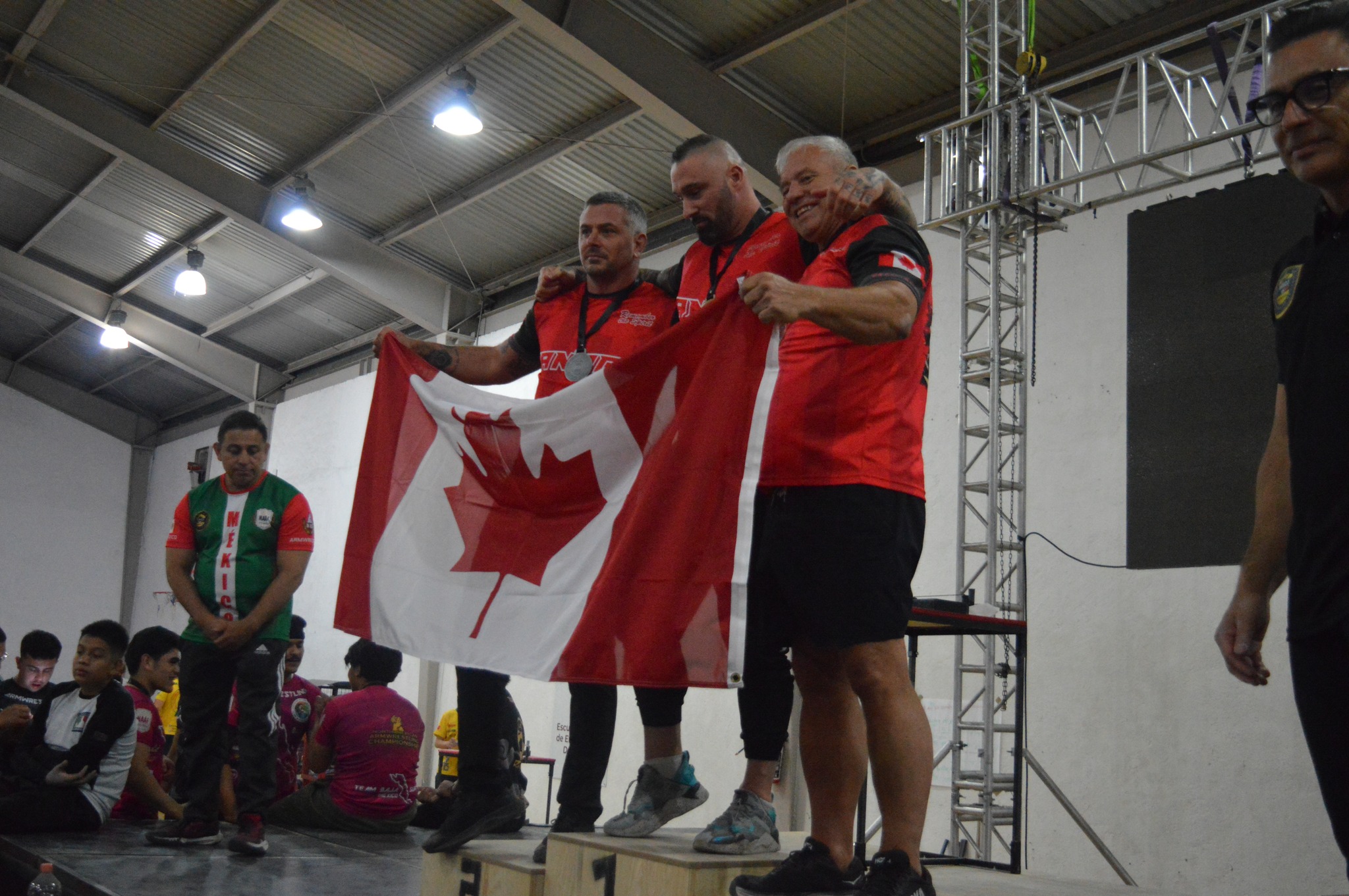 Team Canada athletes celebrating together on the podium